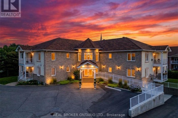 Exterior of a brick apartment building at sunset with a vibrant orange sky. - 103 - 32 La Croisee Street, Russell