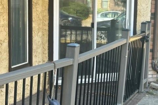 Close-up of the patio railing with a view of the sliding glass door. - 103 507 Tait Crescent, Saskatoon