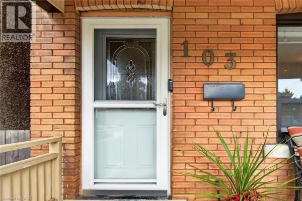 Close-up of the front door with the house number 103 and a mailbox mounted on the brick exterior. - 103 Belmont Avenue, Hamilton
