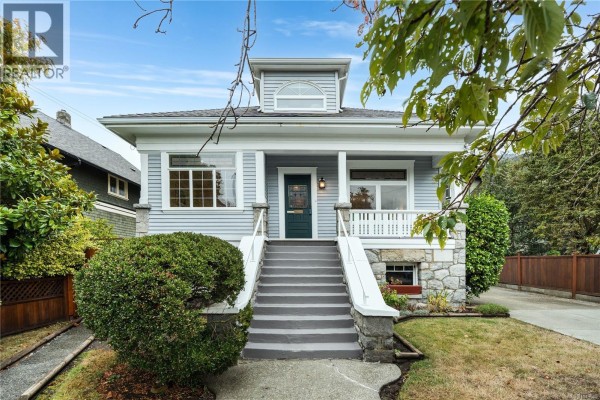 Front view of the house with a grey exterior, white trim, stone accents, a porch with columns, and stairs. - 103 Bushby St, Victoria
