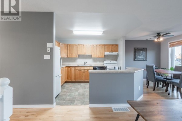 Kitchen with light wood cabinets and countertops, open to the dining area. - 103 Cedar Green Drive, Garson