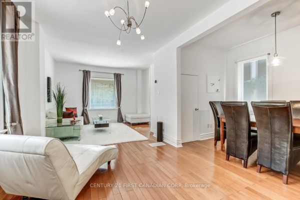 Open-concept living and dining area with light wood floors, white walls, modern furniture, and a dining set. - 103 Edward Street, London South
