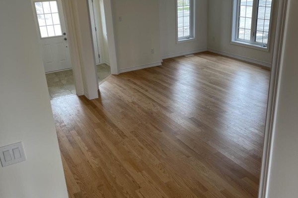 View of a room with hardwood floors, a doorway, and large windows. - 103 Nottingham Road, Barrie