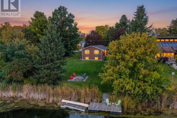 Aerial view of a home with a lake, dock, and campfire area in autumn. - 103 Rocklind Close Lane, Front Of Leeds & Seeleys Bay
