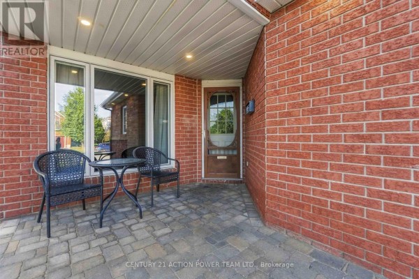 Covered front porch with two chairs and a small table. - 1032 Sheenboro Crescent, Ottawa