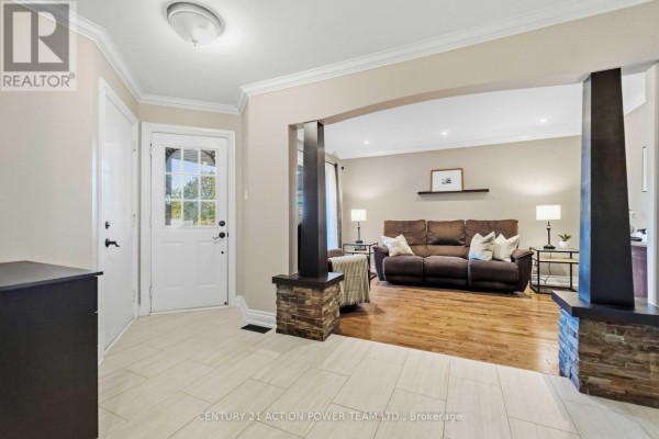Entrance hallway with beige walls and cream floor tiles. - 1032 Sheenboro Crescent, Ottawa