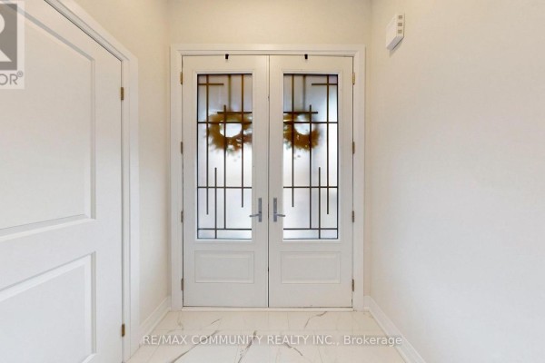 View from inside the foyer looking at the black double entry doors. - 1034 Skyridge Boulevard, Pickering