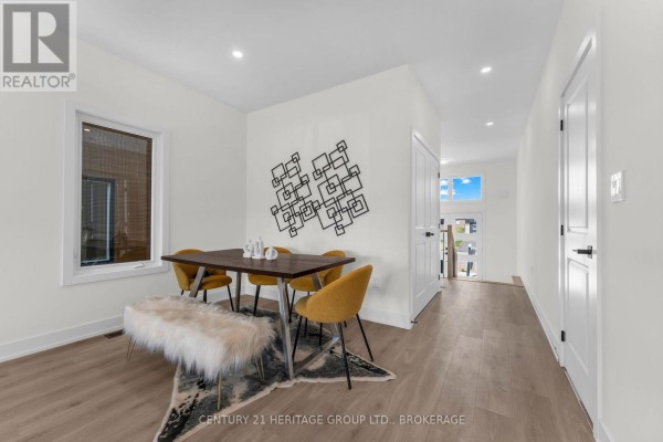 Dining area with table, chairs, bench, and geometric wall art. - 104(lot 55) Creighton Drive, Loyalist