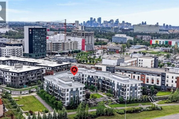 View of the apartment building with city skyline in the background. - 104, 383 Smith Street Nw, Calgary
