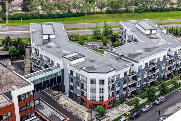 Aerial view of the building's exterior from a high angle showing multiple sections. - 104, 383 Smith Street Nw, Calgary