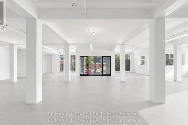 Spacious commercial unit with plywood flooring and windows overlooking the street. - 104 - 14 Mccaul Street, Toronto