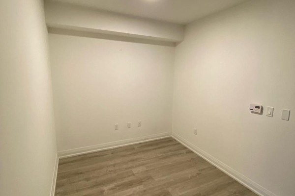 Small room with light-colored walls and laminate flooring - 104 - 30 Gibbs Road, Toronto