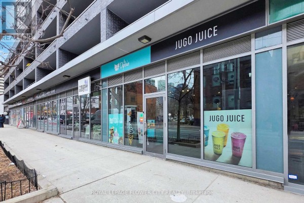 Dark wood shelving units and counter area with a black stool. - 104 - 320 Richmond Street, Toronto