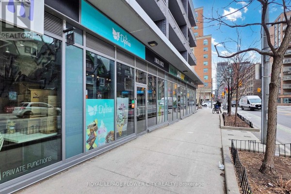 Desk area with white countertop, slatted wall panels, and shelving units. - 104 - 320 Richmond Street, Toronto