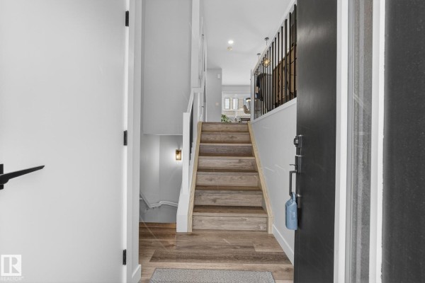 Aerial view of townhouse complex with snow and city lights in the background - #104 50 Ebony Bv, Sherwood Park