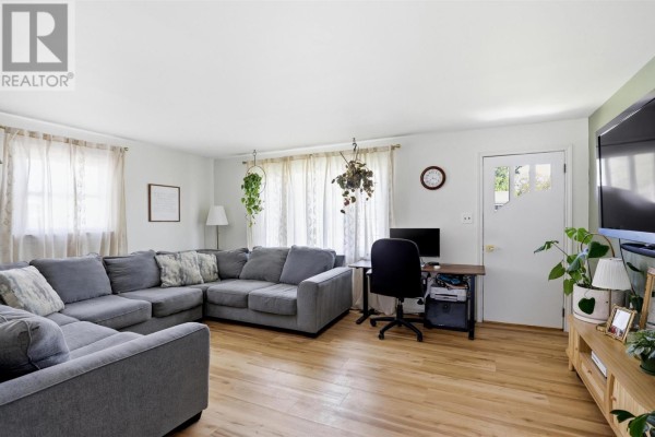 View into a bedroom with a pink metal bed frame from the hallway. - 104 Eastern Ave, Sault Ste  Marie