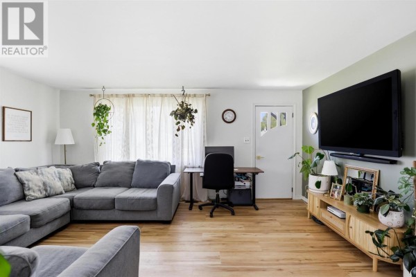 Bedroom with a white dresser, wooden built-in closet, and a window to the right. - 104 Eastern Ave, Sault Ste  Marie