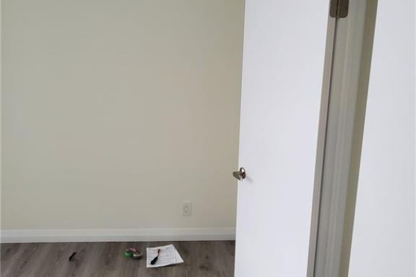 Empty room with light beige walls and an open white door. - 104 Garment Street Unit# 803, Kitchener