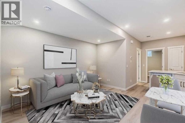 Living room with grey sofa, abstract art, and marble-look coffee table. - 1040 Mahogany Boulevard Se, Calgary