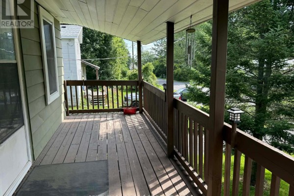 View from the covered wooden porch overlooking the yard and a portion of the street. - 10407 Hainsville Road, South Dundas