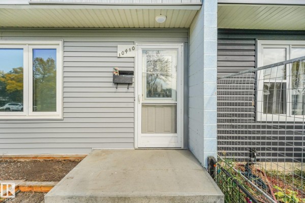 Close-up of the townhouse front door with address 10410 and a mailbox. - 10410 Lauder Av Nw, Edmonton