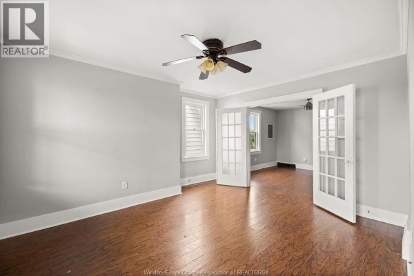 Living room with light grey walls, wood floors, ceiling fan, and french doors. - 1044 Parent Avenue Unit# Upper, Windsor