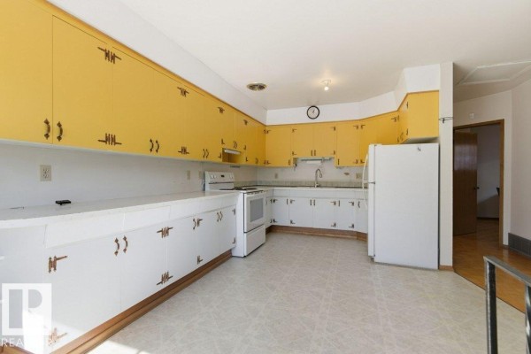 Floor plan of a house showing living, dining, kitchen, and bedroom layouts. - 10459 66 Av Nw, Edmonton