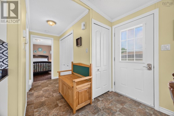 Interior hallway with a wooden bench, closet doors, and a view into a bedroom. - 1047 Glen Forest Drive, Westville