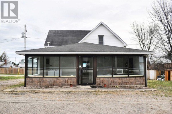 Sunroom addition with floor-to-ceiling windows and a brick foundation attached to the main building. - 10494 & 10496 Highway 17, West Nipissing
