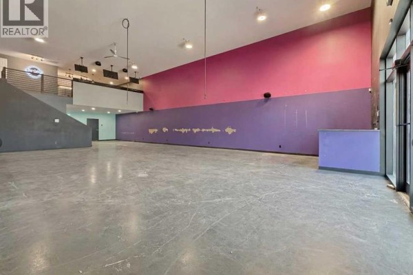 Another angle of the kitchen showing equipment and workspace with modern fixtures. - 105, 245 Canal Avenue, Strathmore