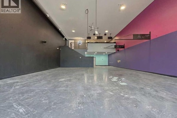 Kitchen area featuring countertops, sinks, and various supplies in a commercial setting. - 105, 245 Canal Avenue, Strathmore