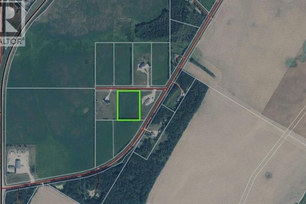Aerial overview of a rural area showing multiple land parcels, roads, houses, and green fields. - 105, 68164 Campsite Road, Plamondon
