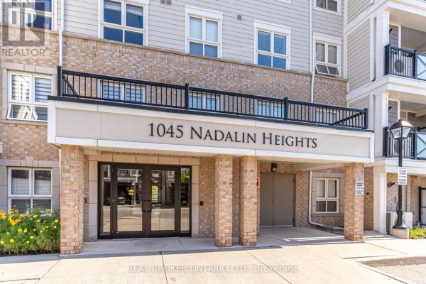 Entrance to 1045 Nadalin Heights apartment building with brick accents and glass double doors. - 105 - 1045 Nadalin Heights, Milton
