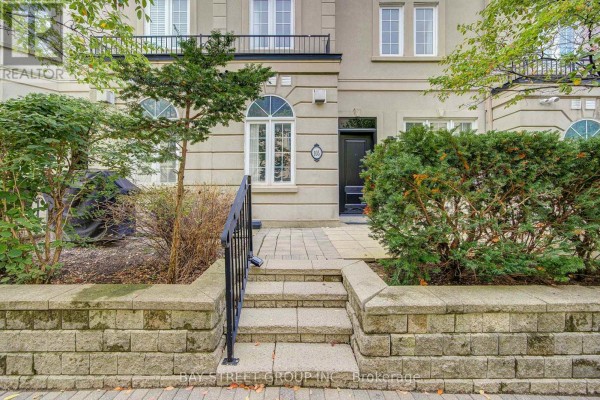 Stone steps and walkway leading to the entrance of a beige townhouse. - 105 - 11 Everson Drive, Toronto