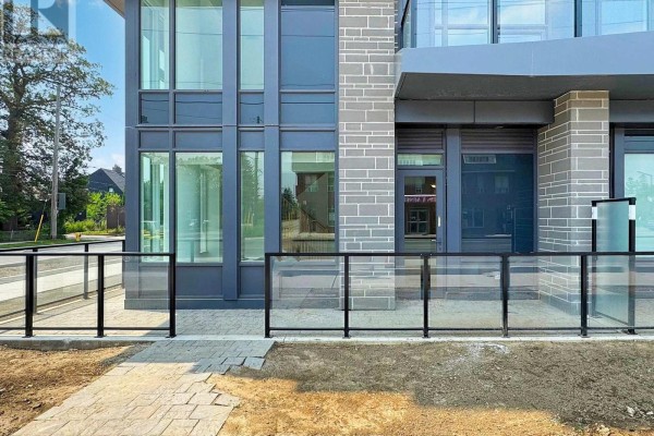 Entrance area of a condominium building with glass railings and stone pavers. - 105 - 556 Marlee Avenue, Toronto