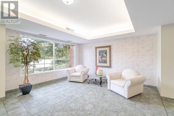 A staged bedroom with a white bed, wood floor, and framed art on the wall. - 105 - 75 Treelawn Boulevard, Vaughan
