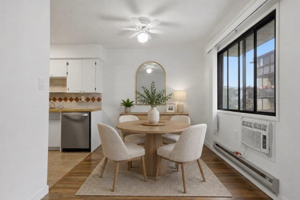 Dining area with a round wood table, four chairs, and a window with a view. - 105 32033 Old Yale Road, Abbotsford
