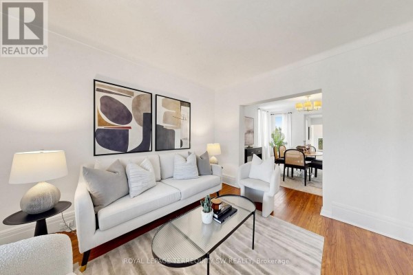 Another view of the living room featuring hardwood floors and natural light from the window. - 105 Barker Avenue, Toronto