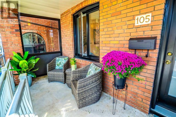 Covered front porch with wicker chairs, a small table, and flower pot. - 105 Earlscourt Avenue, Toronto