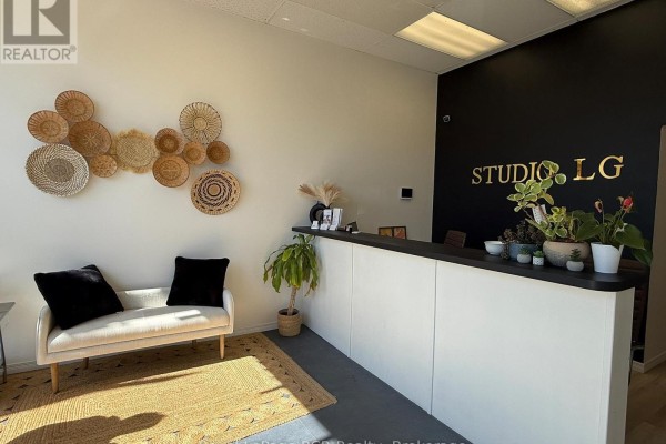 Reception area with wooden counter, vintage couch, and product display. - 105 Garafraxa Street S, West Grey
