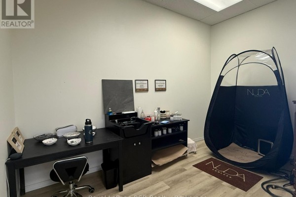 Living area with polished hardwood floors and a view of the street. - 105 Garafraxa Street S, West Grey