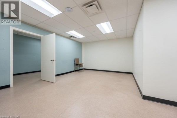View of the side and front of the Delhi Community Health Centre building with parking lot. - 105 Main Street Unit# B, Delhi