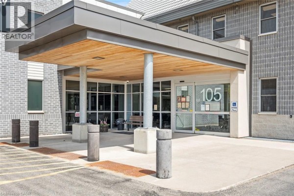 Covered entrance of a commercial building with glass doors and concrete pillars. - 105 Main Street Unit# D, Delhi