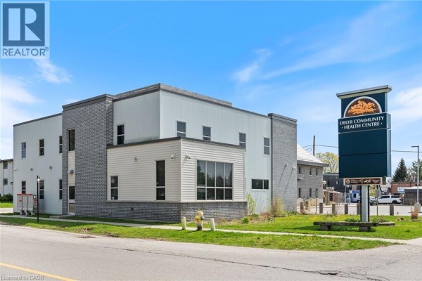 Side view of a commercial building with signage for Delhi Community Health Centre. - 105 Main Street Unit# D, Delhi