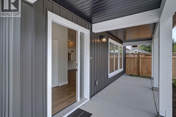 Interior entryway with a white door, a large white double closet, and light wood laminate flooring. - 1051 Celia Crescent, Gibsons