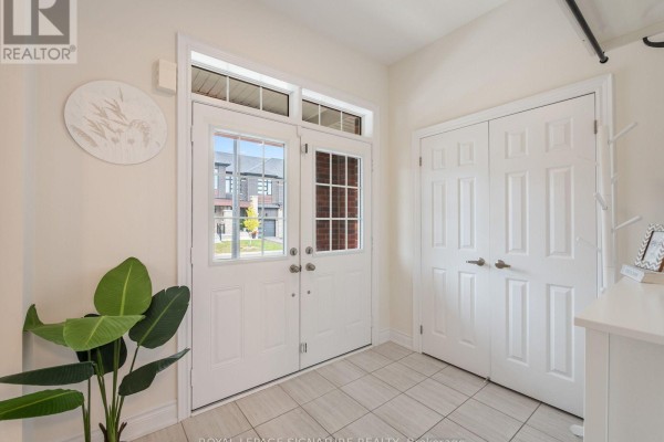 Front entrance with double doors and tiled flooring, overlooking the street. - 1055 Skyridge Boulevard, Pickering
