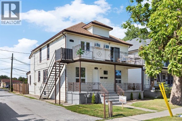 Side exterior view of the multi-family house showing the entrance and windows. - 1056-1060 Niagara, Windsor