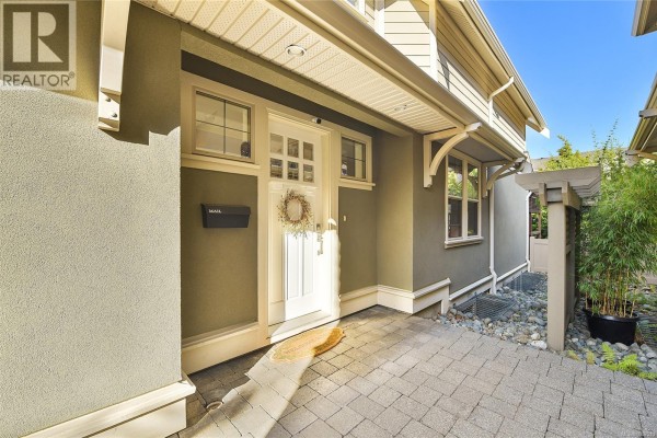 Covered front entrance with a white door, sidelights, a mailbox, and a paved walkway. - 1059 Clare St, Victoria