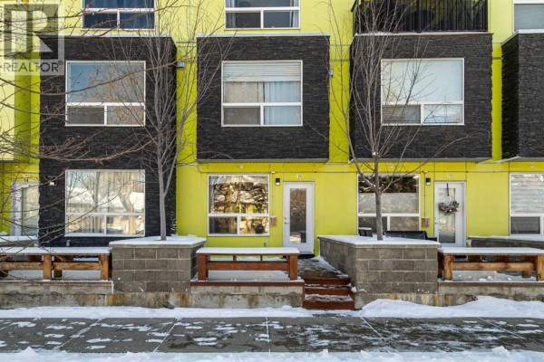 Second bedroom with window, light curtains, and a bed - 106, 1740 9 Street Nw, Calgary