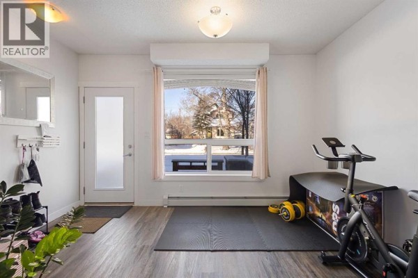 Bathroom featuring a tub, modern vanity, and neutral tiles - 106, 1740 9 Street Nw, Calgary
